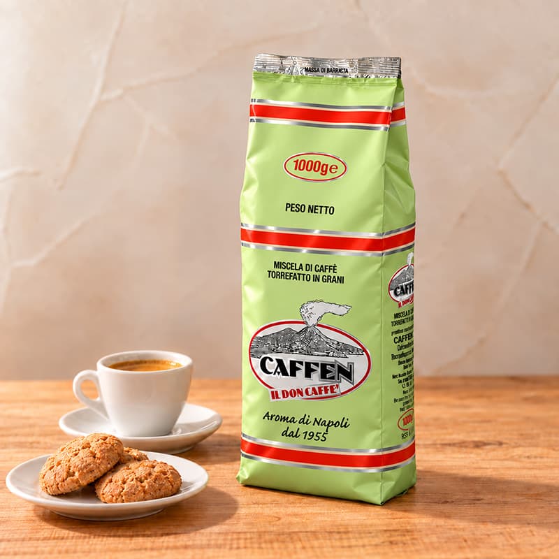 カフェン（CAFFEN）のコーヒー豆1kg入りの緑色パッケージと、エスプレッソ、白い皿に盛ったクッキー
